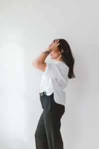Owner of Hudson Valley Beauty Lab poses in minimalist studio during personal branding photography session with Pine & Fable Photography.
